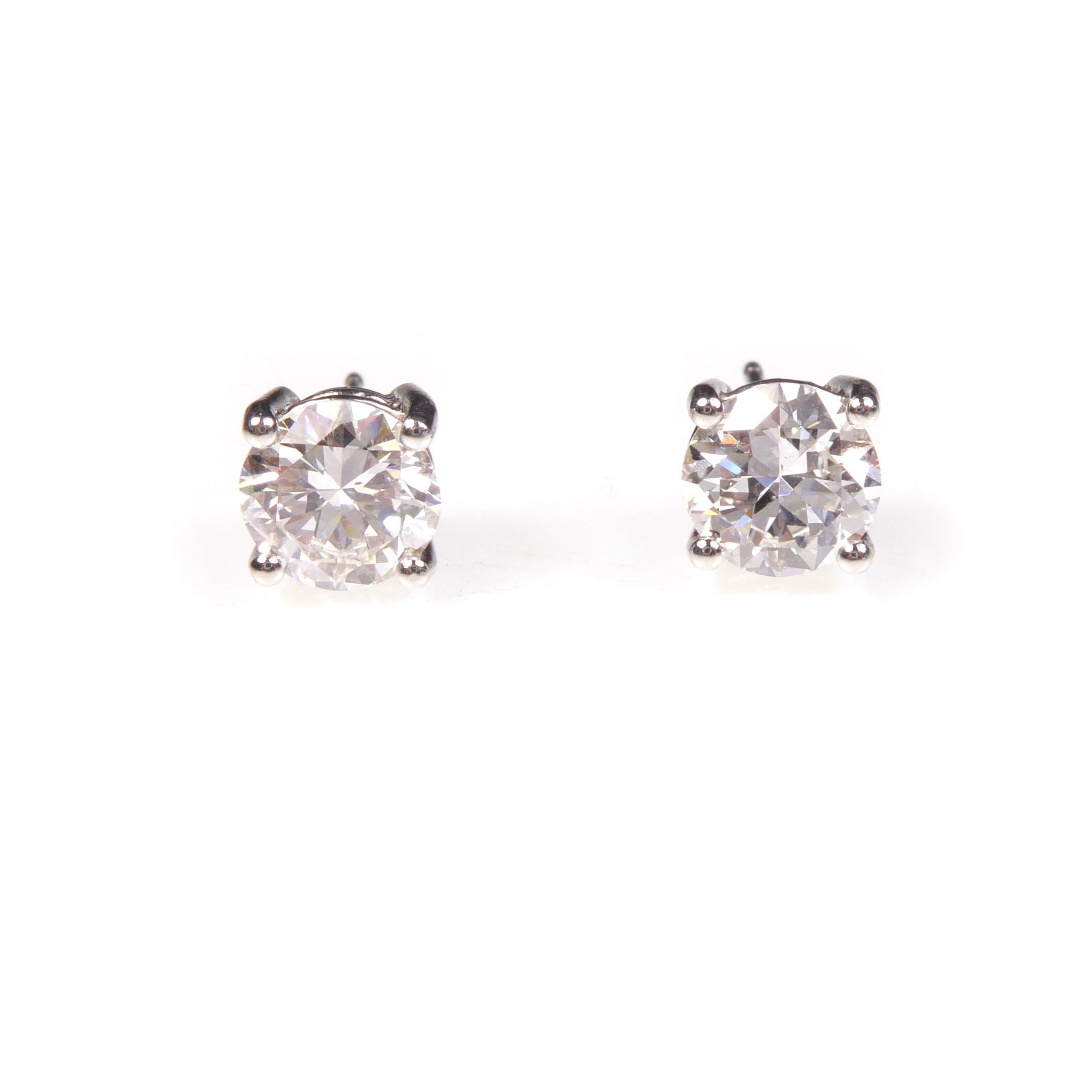 Pair of round brilliant cut diamond stud earrings, four claw set, the modern cuts each of 1.00ct G SI1,